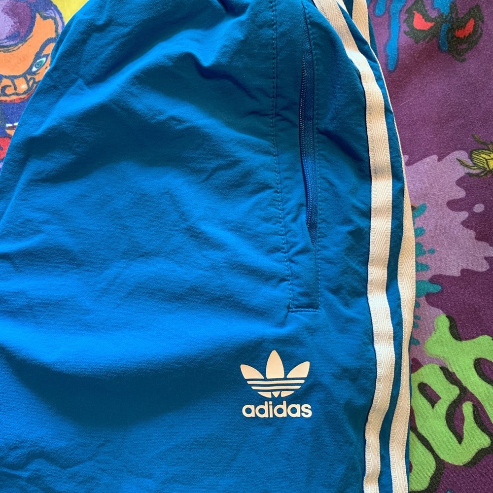 Adidas blue track pants.